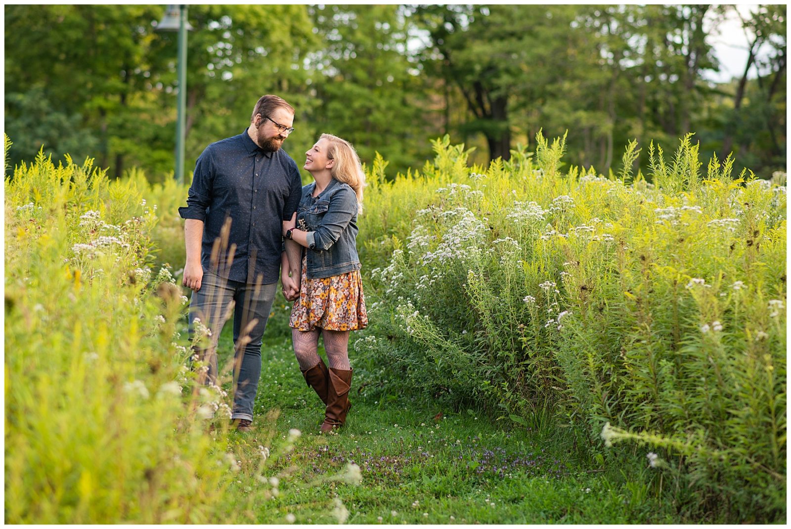 An August Ohio Engagement Session, fun and candid photos, engagement session outfit ideas, blue button down, jean jacket, outfit ideas, silly moments, wildflower field, metropark engagement session